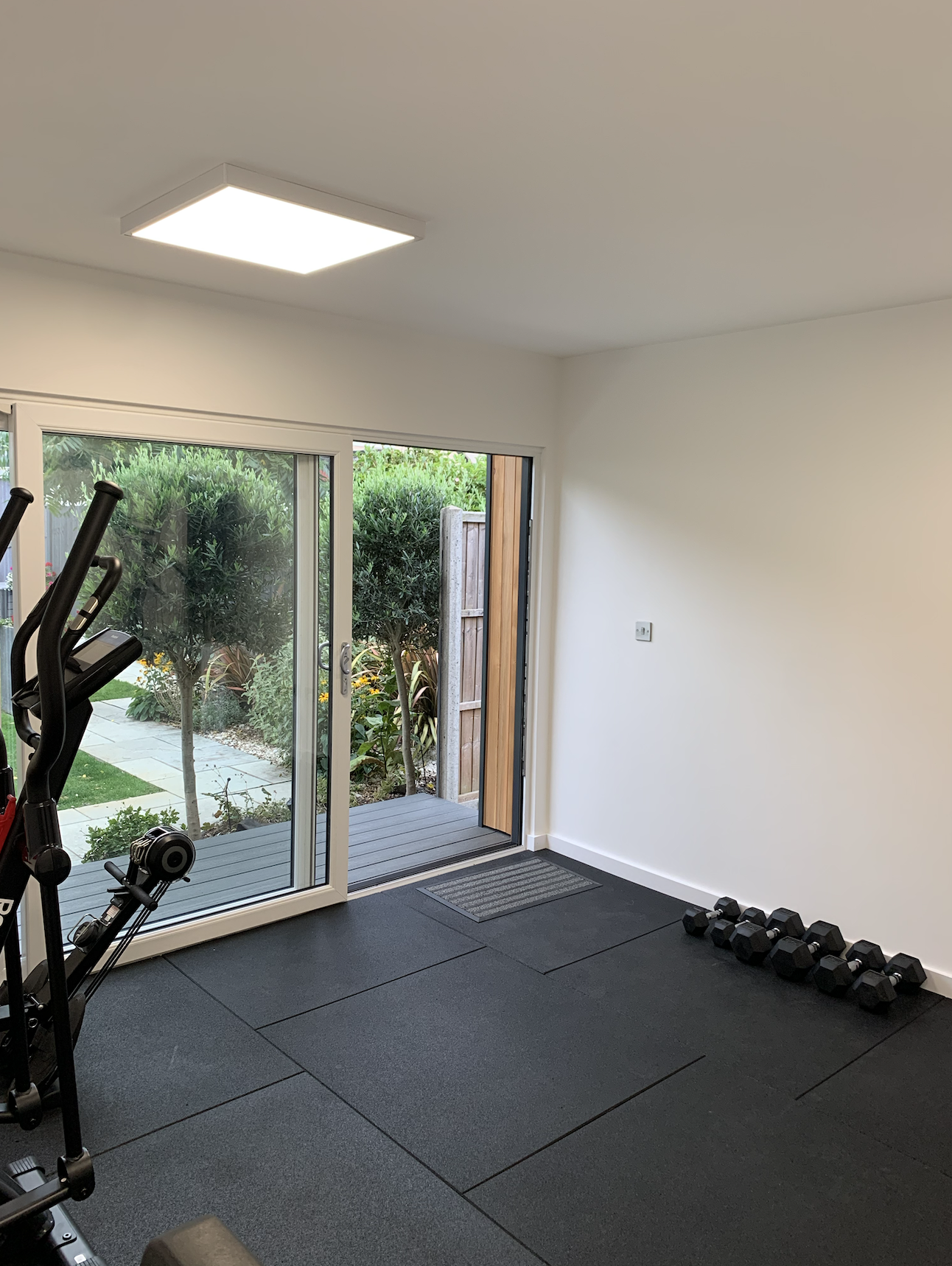 Contemporary garden room configured as home gym