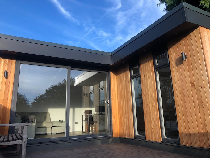 Contemporary corner garden room with wooden cladding
